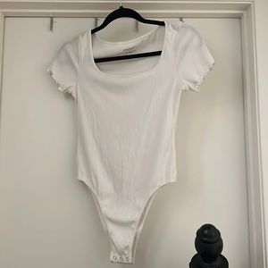 bodysuit. white. square neckline. ruffled sleeves.